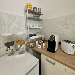 Een koelkast met diepvriezer, een microgolfoven, een kookplaat