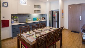 A modern kitchen with white cabinets, a built-in oven, and a refrigerator. - Luxury Apartment Vinhomes Metropolis 02 BR#5**Sky View# (Hà Nội)