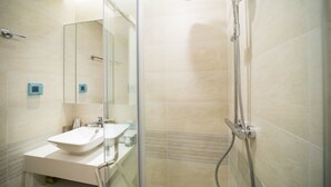 A modern bathroom with a glass-enclosed shower, a white sink, and a mirror. - Luxury Apartment Vinhomes Metropolis 02 BR#5**Sky View# (Hà Nội)