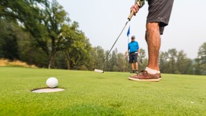 A golf course with a golf ball on the tee and a golfer preparing to take a shot. - Perfect for larger groups, fantastic view to Red Mountain (Rossland)