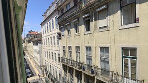 A multi-story building with balconies, a street view, and parked cars. - LV Premier Baixa DO1 (Lisbon)