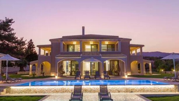 A two-story house with a swimming pool, outdoor seating, and a well-lit entrance. - Villa Onore - Luxurious pool jacuzzi (Dassia)