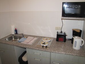 Fridge, stovetop, electric kettle, cookware/dishes/utensils