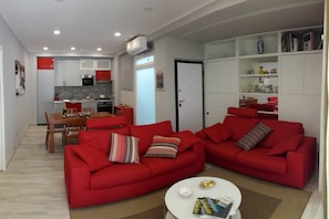 A modern apartment with a kitchen, dining area, and living room.