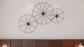 A ceiling with three circular wall art pieces.