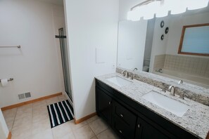 Bathtub, hair dryer, towels, toilet paper