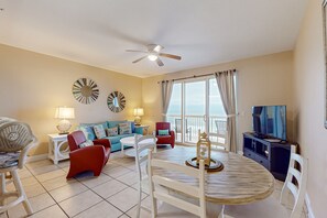 Relax in this inviting living area with a round dining table and comfortable seating for a cozy evening in.