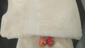 A white towel folded on a dark surface.