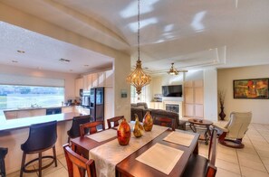 Cozy living area with a dining table for four, comfortable seating, and a modern kitchen.