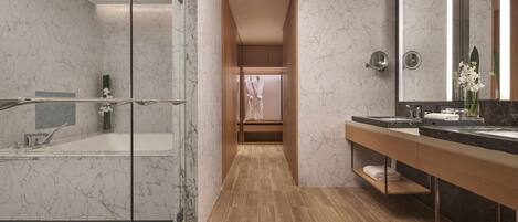 A modern bathroom with a glass-enclosed shower, a wooden vanity with a black countertop, and a marble-tiled floor.