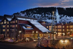 Traditional hotel with a prominent entrance and mountain views.