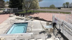 A swimming pool with lounge chairs and a view of a lake and mountains. - Inn Building Condo #209-Beautifully updated, view of Bear Lake (Garden City)