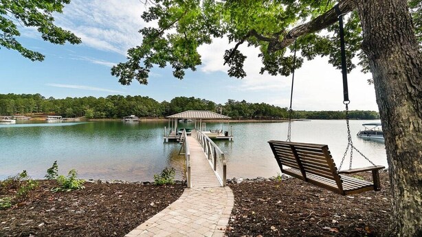 A dock extending into a lake with a swing chair and a bench under a tree. - Stay awhile and RELAX at Lake Keowee, Clemson and the mountains!
The 5 Seasons (West Union)