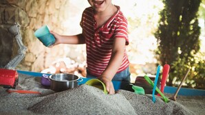 A child playing with sand and toys in an outdoor setting. - Borgo del Sole Agriturismo (San Romano in Garfagnana)