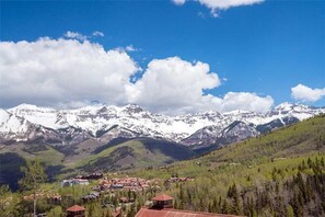 A mountainous landscape with snow-capped peaks and a village with red-roofed buildings. - Cassidy Ridge C301- Fawns Leap (Telluride)