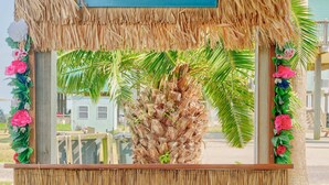 A beach-themed kiosk with a sign reading "CRYSTAL BEACH, TX" and another sign below it stating "BELLA COSTA". - Bella Costa: Good Vibes & Ocean Tides (Bolivar Peninsula)