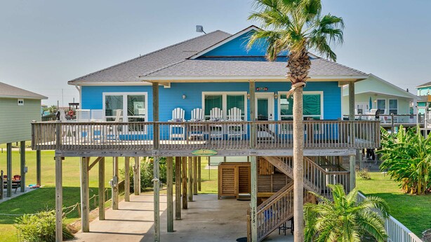 A two-story house with a balcony, a pool, and a staircase leading to the upper level. - Bella Costa: Good Vibes & Ocean Tides (Bolivar Peninsula)