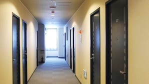 A hotel hallway with doors numbered 201, 202, and 203. - Station Business Hotel Tenshukaku Hitoyoshi (Hitoyoshi)
