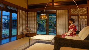 A traditional Japanese room with tatami flooring, a low table, and sliding doors. - Iizukatei (Nakagawa)