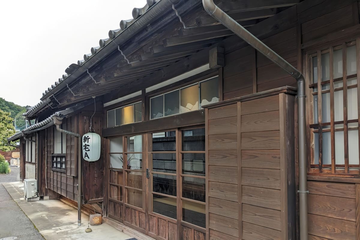 A traditional wooden building with a sign indicating a new establishment.