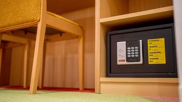 A safe with a keypad and instructions, placed in a wooden cabinet.