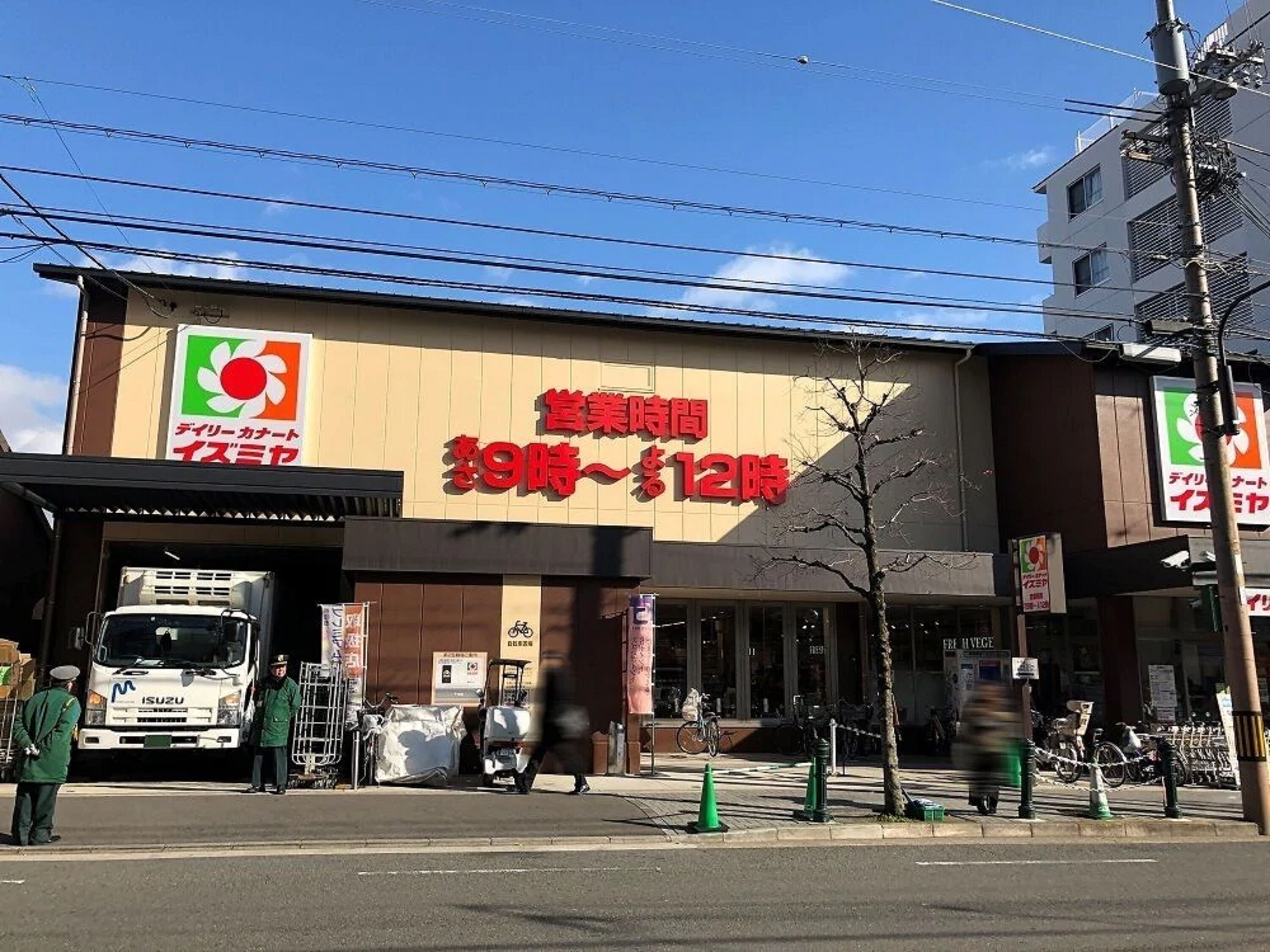A commercial building with a large sign indicating business hours from 9 AM to 12 PM.