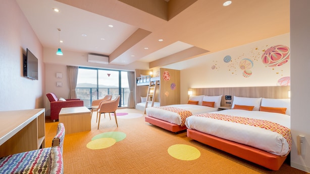 A hotel room with two beds, a desk, a chair, and a view of the city. - RESI STAY Nishijin  (Kyoto)