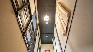 A staircase with wooden steps and a dark ceiling. - Kiyomizuya (Kyoto)