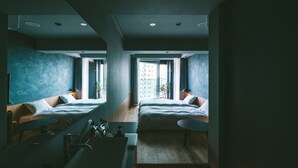 A modern hotel room with two beds, a small desk, a bathroom, and large windows offering a city view. - LANDABOUT TOKYO (Tokyo)