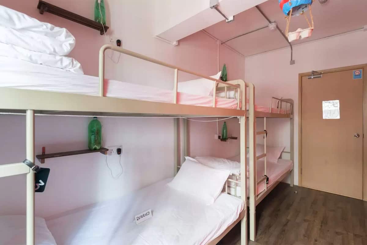 A bunk bed room with a 'RESERVED' sign on the lower bunk.