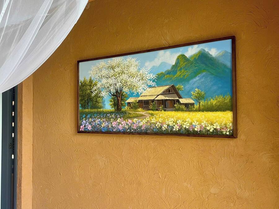 A painting of a house with a tree and flowers on a textured wall.