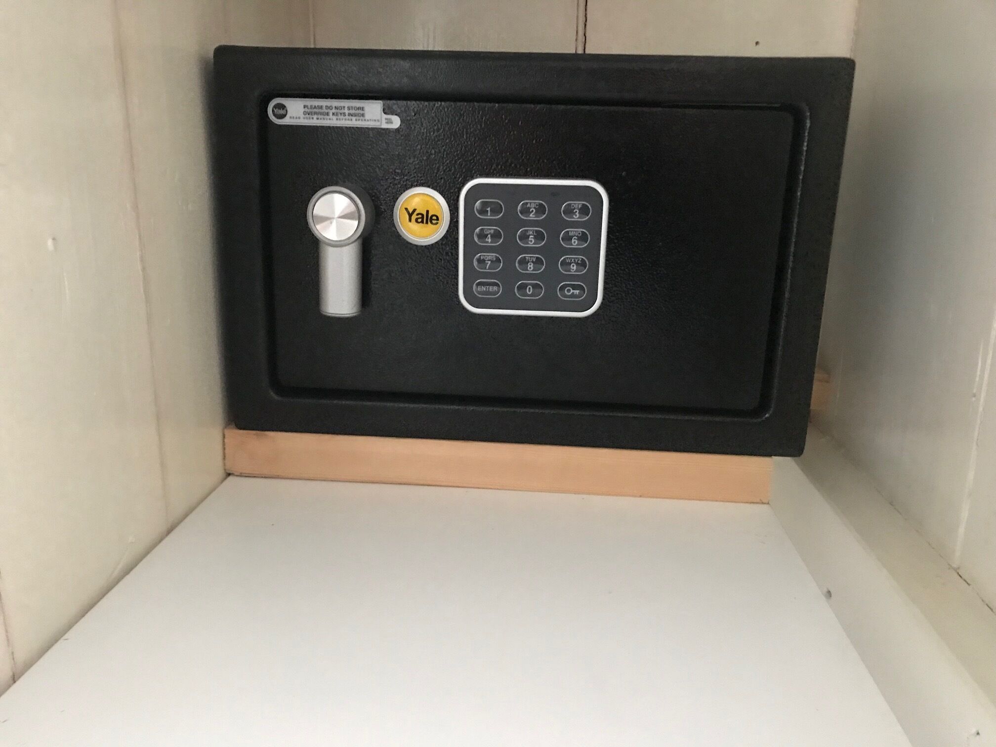 A Yale combination safe with a keyhole and a keypad.