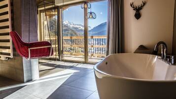 Bathtub, hair dryer, towels, toilet paper