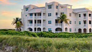 A multi-story building with balconies and a beach view. - TRUE OCEANFRONT OASIS • 2BR • First Floor • Private Beach • Large Pool & Hot Tub (Wheeland Settlement)