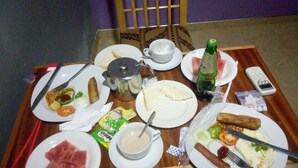 A table set with various breakfast items including eggs, sausages, and toast. - Great Mission Hotel (Oda)