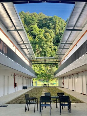 A covered outdoor area with a view of a forested hillside. - The Sassy House (Langkawi)