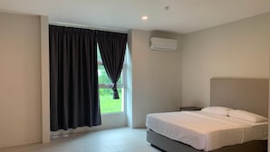 A modern hotel room with a large bed, a window with curtains, an air conditioning unit, and a tiled floor. - The Sassy House (Langkawi)