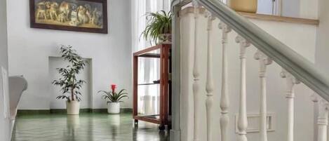 A marble staircase with white balusters leading to a landing.