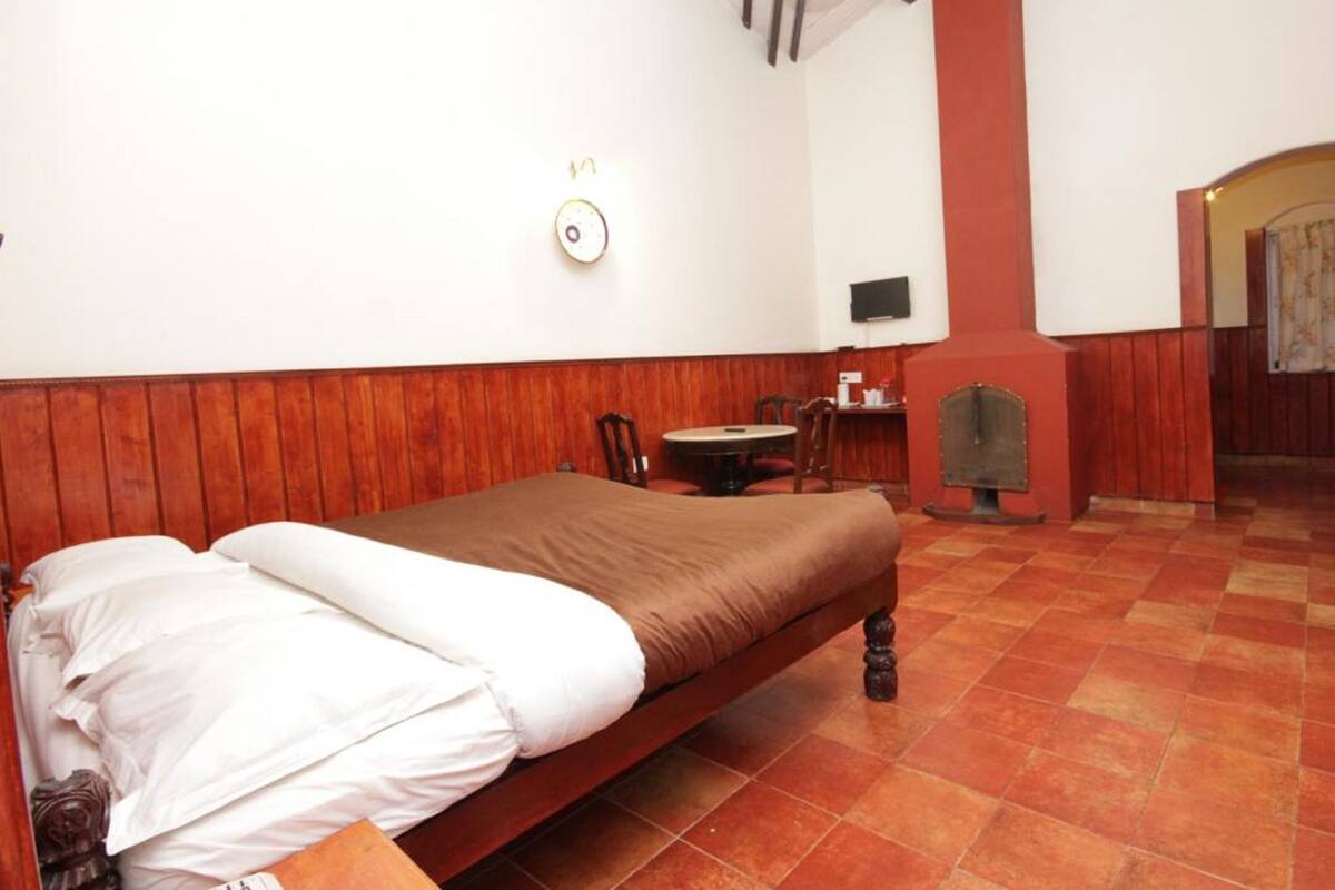 A room with a bed, a table, and a chair.