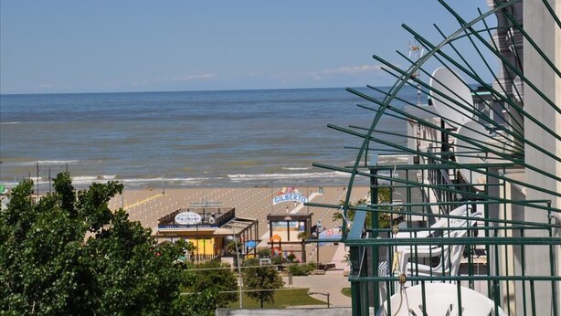 Vista de una playa con un edificio que dice 'GILBERTO'.