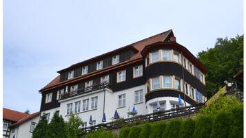 A multi-story building with a black and white facade, multiple windows, and balconies.