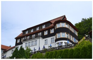 Un immeuble à plusieurs étages, doté d’une façade noire et blanche, de nombreuses fenêtres et de balcons.