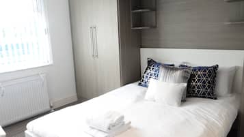 Hypo-allergenic bedding, desk, laptop workspace, blackout curtains