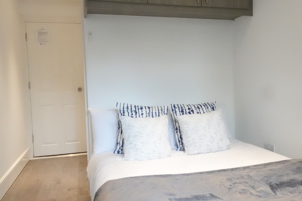 Hypo-allergenic bedding, desk, laptop workspace, blackout curtains