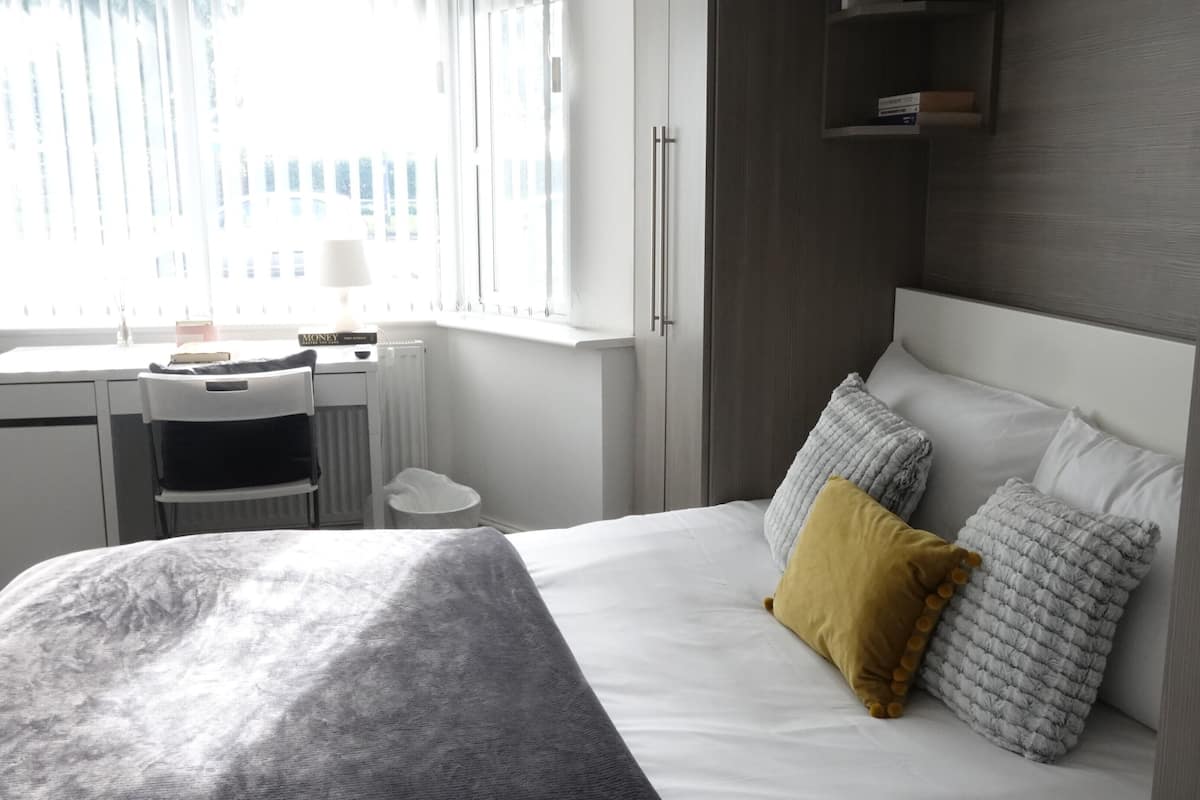Hypo-allergenic bedding, desk, laptop workspace, blackout curtains