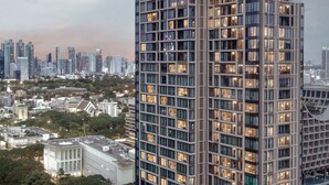 A high-rise building with multiple floors, large windows, and a modern architectural design. - Kimpton Maa-Lai Bangkok by IHG (Bangkok)