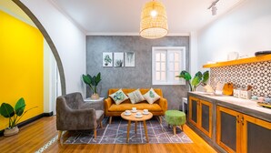 A modern living room with a sofa, coffee table, and plants. - Chin Stays - Hotel and Apartment (Da Nang)