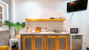 A compact kitchen with a microwave, toaster, and small refrigerator. - Chin Stays - Hotel and Apartment (Da Nang)