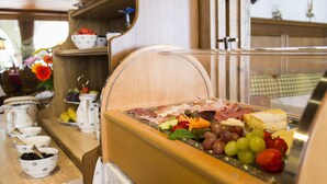 A breakfast buffet with various cheeses, meats, and fruits. - Hotel Gasthof Jägerstüble (Freudenstadt)