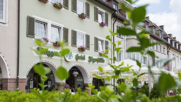 A hotel facade with a sign reading "Hotel St. Georg," featuring arched windows and flower boxes. - Hotel Gasthof Jägerstüble (Freudenstadt)